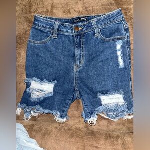 Fashion nova jean short denim. Wore once. Size 7(28). Distressed frayed shorts.